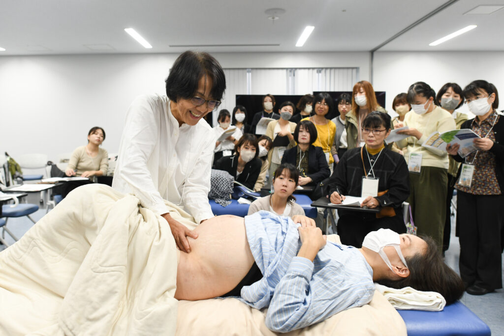 A midwife educator provides clinical care to a patient.